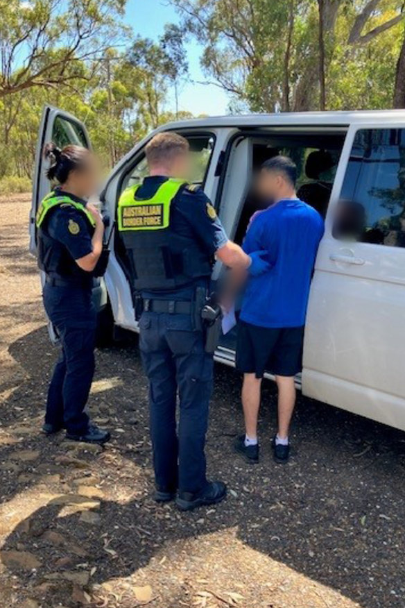 Border force officers detain an unlawful freight driver during a nationwide crackdown