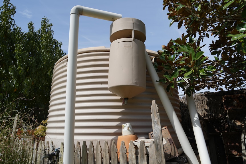A water tank in a backyard.
