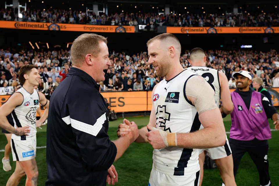 Pictured right to left, former Carlton captain Sam Docherty and coach Michael Voss.