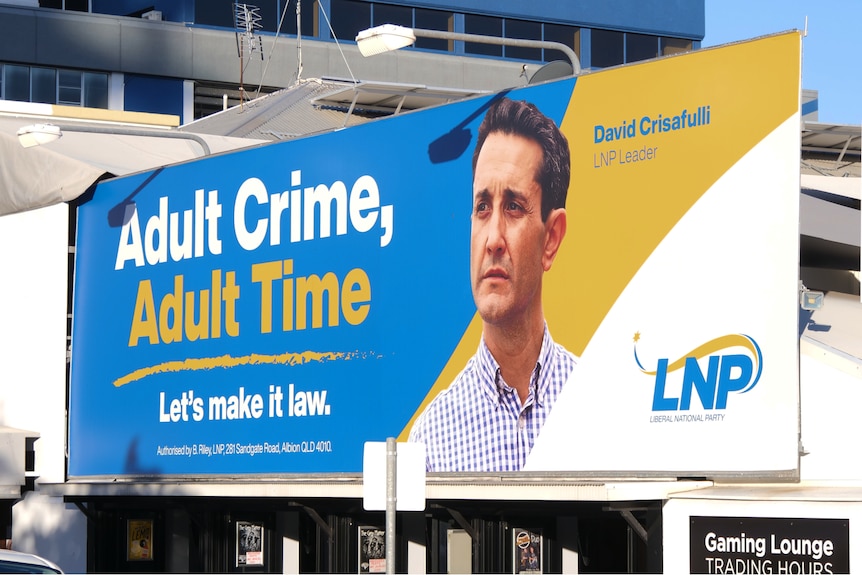 Large billboard of man with politcal slogans