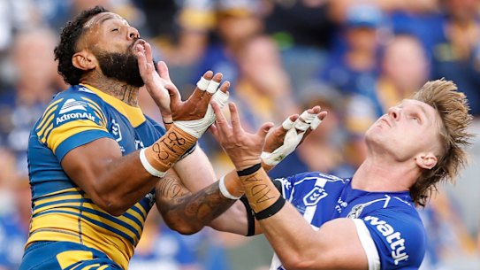 Jacob Preston and Josh Addo-Carr compete for the ball.
