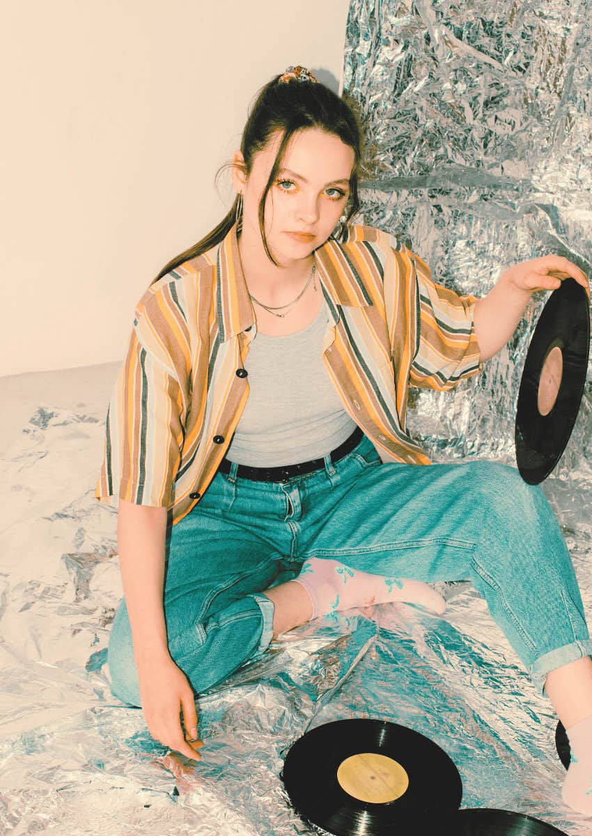 80s theme of young woman holding a vinyl record