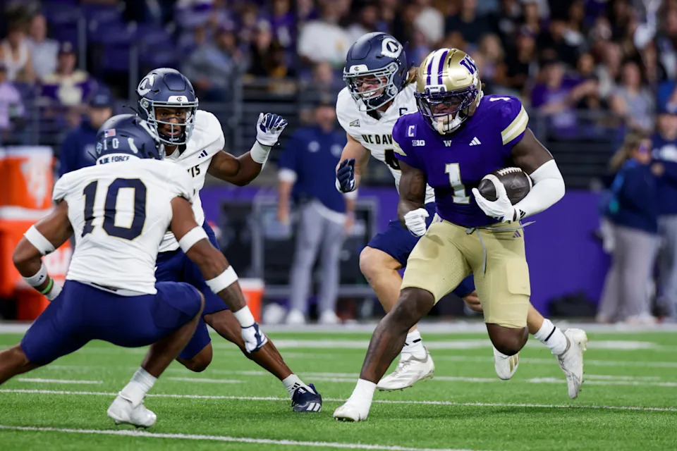 Sep 6, 2025; Seattle, Washington, USA; Washington Huskies running back Jonah Coleman (1) rushes against the UC Davis Aggies during the first quarter at Husky Stadium. Mandatory Credit: Joe Nicholson-Imagn Images