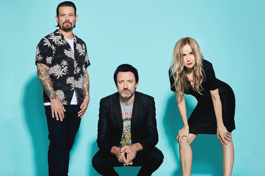 The three members of Something For Kate against a bright blue background