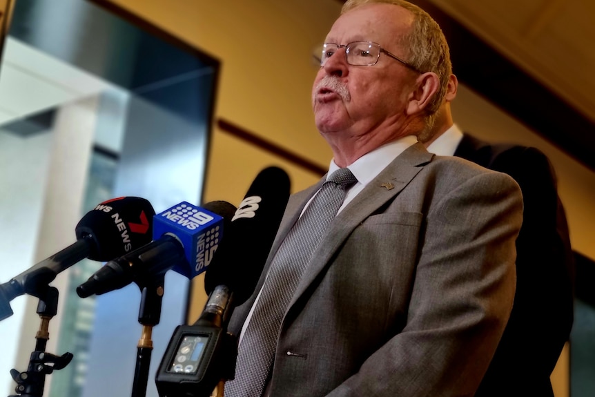 Geoff Brock speaks at a press conference