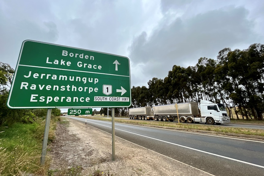 Highway sign with truck on the road.