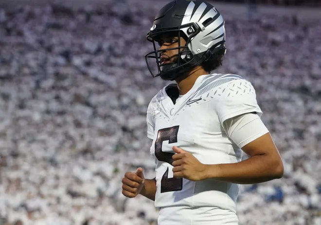 Sep 27, 2025; University Park, Pennsylvania, USA; Oregon Ducks quarterback Dante Moore (5) warms up before a game against the Penn State Nittany Lions at Beaver Stadium. Mandatory Credit: James Lang-Imagn Images