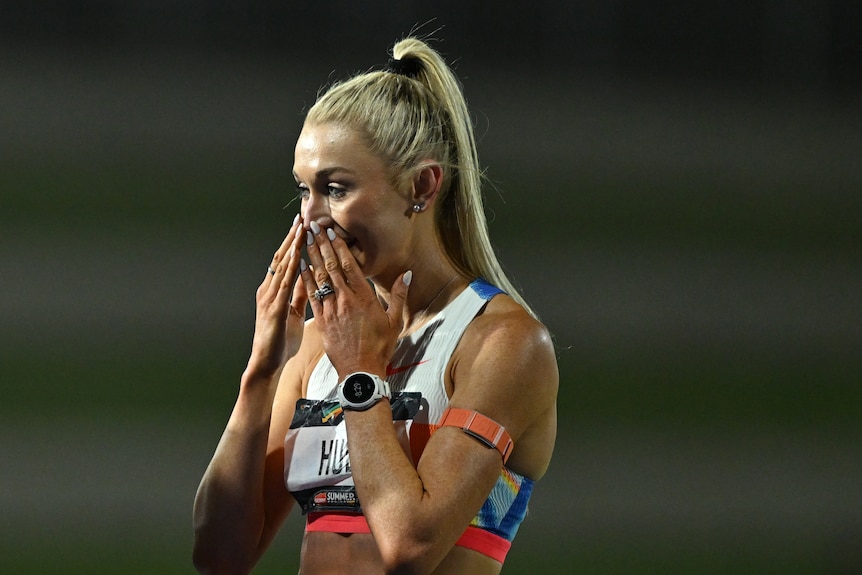 Jess Hull puts her hands to her face with a surprised look on her face