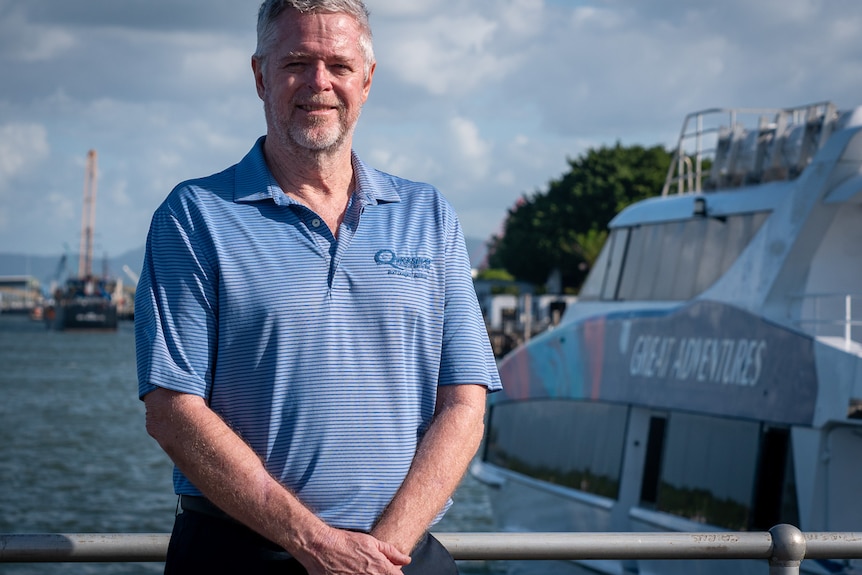 Quicksilver CEO Tony Baker stands at a marina near the water
