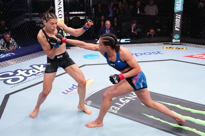 LAS VEGAS, NEVADA - APRIL 04: (R-L) Dione Barbosa of Brazil punches Melissa Gatto of Brazil in a flyweight fight during the UFC Fight Night event at Meta APEX on April 04, 2026 in Las Vegas, Nevada. (Photo by Jeff Bottari/Zuffa LLC)