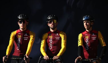 Three Cofidis riders against a moody, dark background