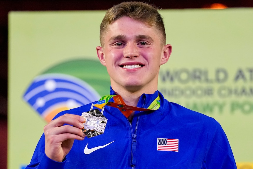 Cooper Lutkenhaus holds his gold medal in his right hand at the World Athletics Indoor Championships.