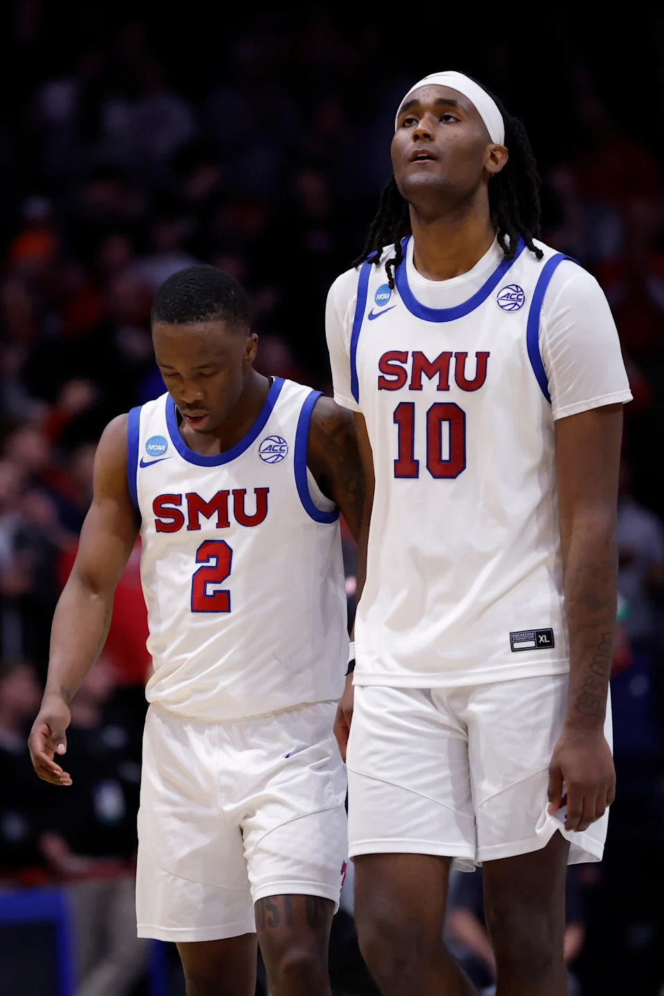 Mar 18, 2026; Dayton, OH, USA; SMU Mustangs guard Boopie Miller (2) and SMU Mustangs center Jaden Toombs (10) leave the court after being defeated by the Miami (OH) RedHawks during a first four game of the men's 2026 NCAA Tournament at University of Dayton Arena. Mandatory Credit: Rick Osentoski-Imagn Images