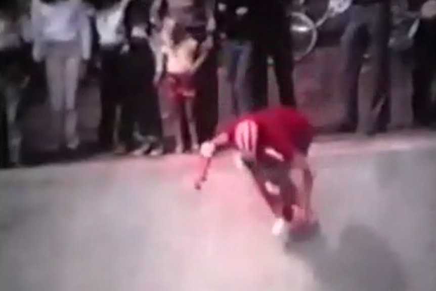 A grainy picture of a skater in a video from 1980.