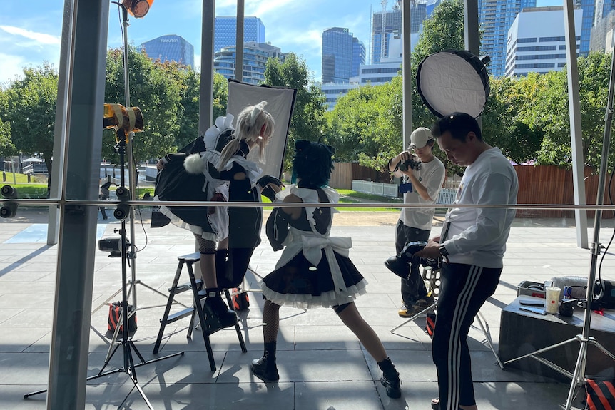 Photographers taking photos of cosplayers