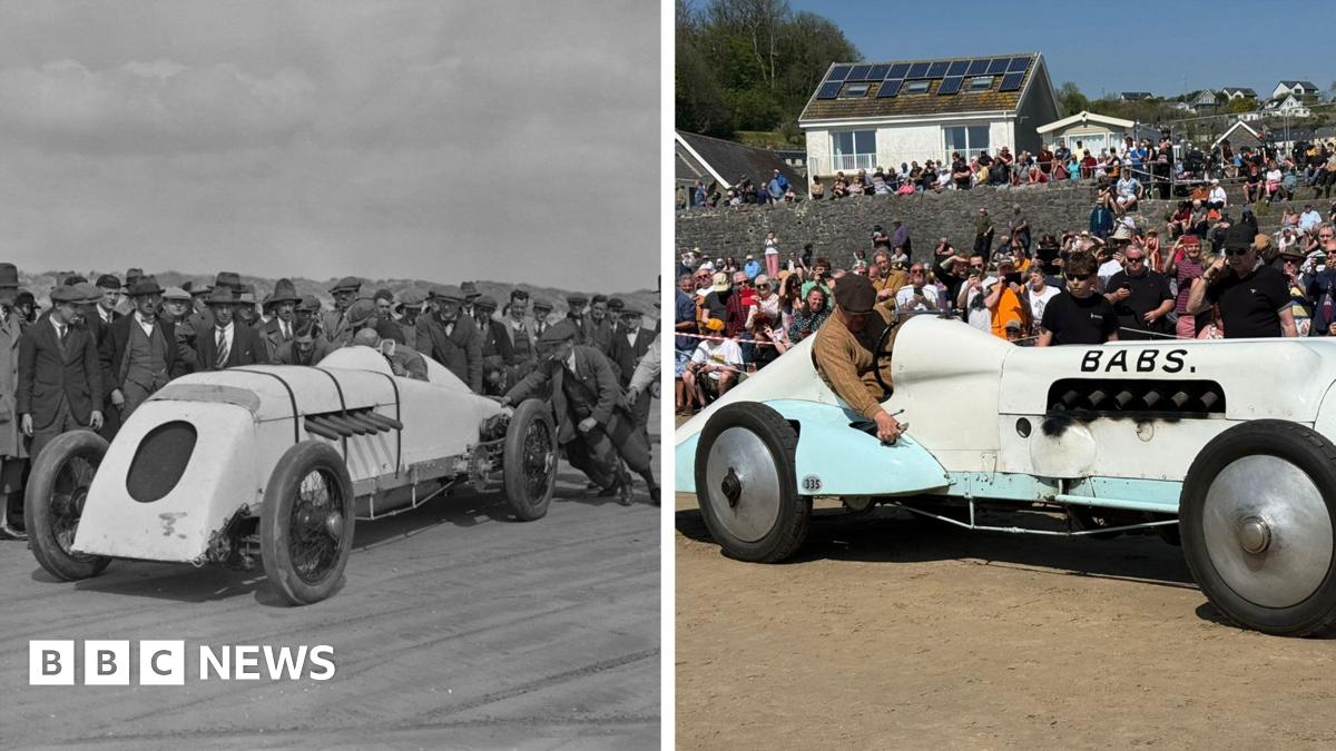A general view of the car 'Babs' with a crowd of spectators behind it. It is white and light blue with 'Babs' written on the side in large letters.