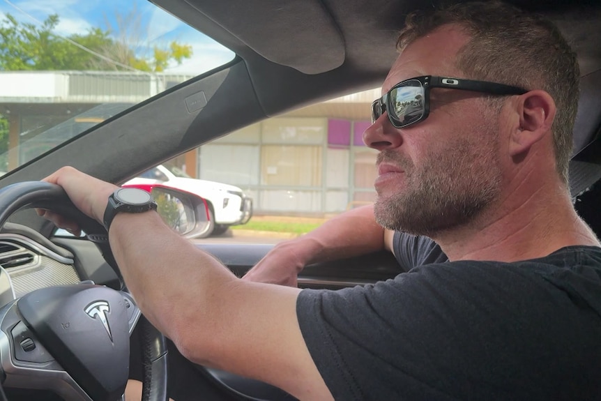 Andy McCarthy driving his electric vehicle