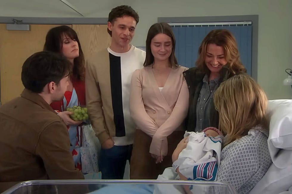 emmerdale, mack, kerry, jacob, sarah, moira, charity, baby leyla in a hospital room, with charity in bed holding the baby