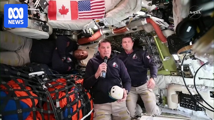 Artemis II crew work inside space capsule on historic lunar mission