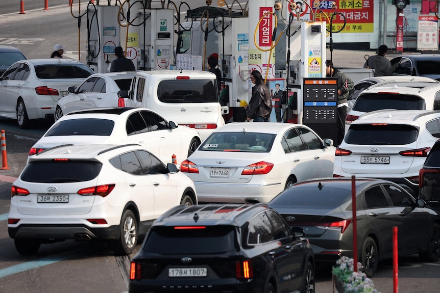 Cars line up at a gas station in Seoul, South Korea.