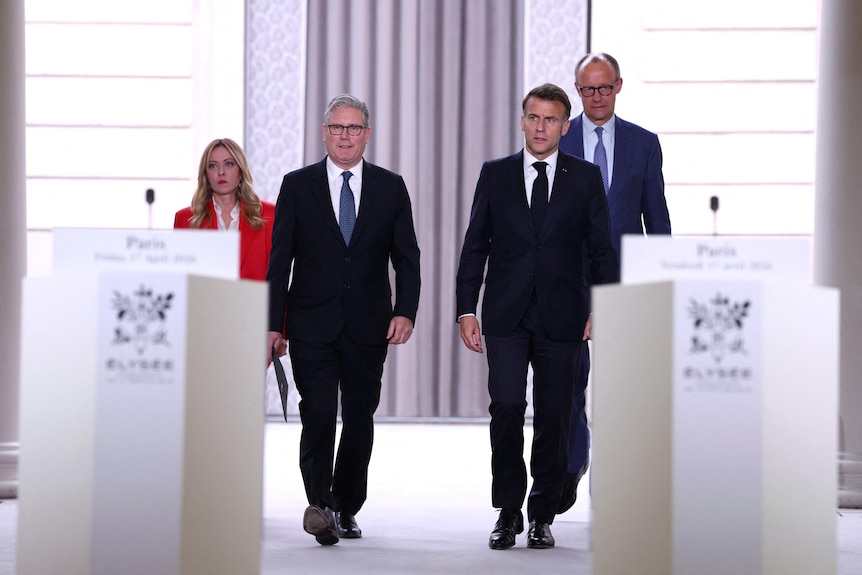 Keir Starmer, Emmanuel Macron, Giorgia Meloni and Frederich Merz walk into a press conference