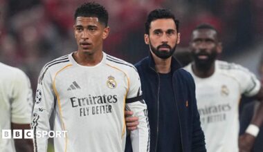 Real Madrid's Jude Bellingham is held back by manager Alvaro Arbeloa after they are knocked out of the Champions League by Bayern Munich