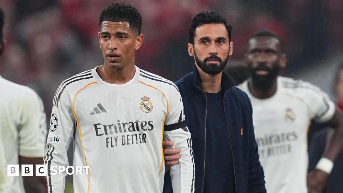 Real Madrid's Jude Bellingham is held back by manager Alvaro Arbeloa after they are knocked out of the Champions League by Bayern Munich