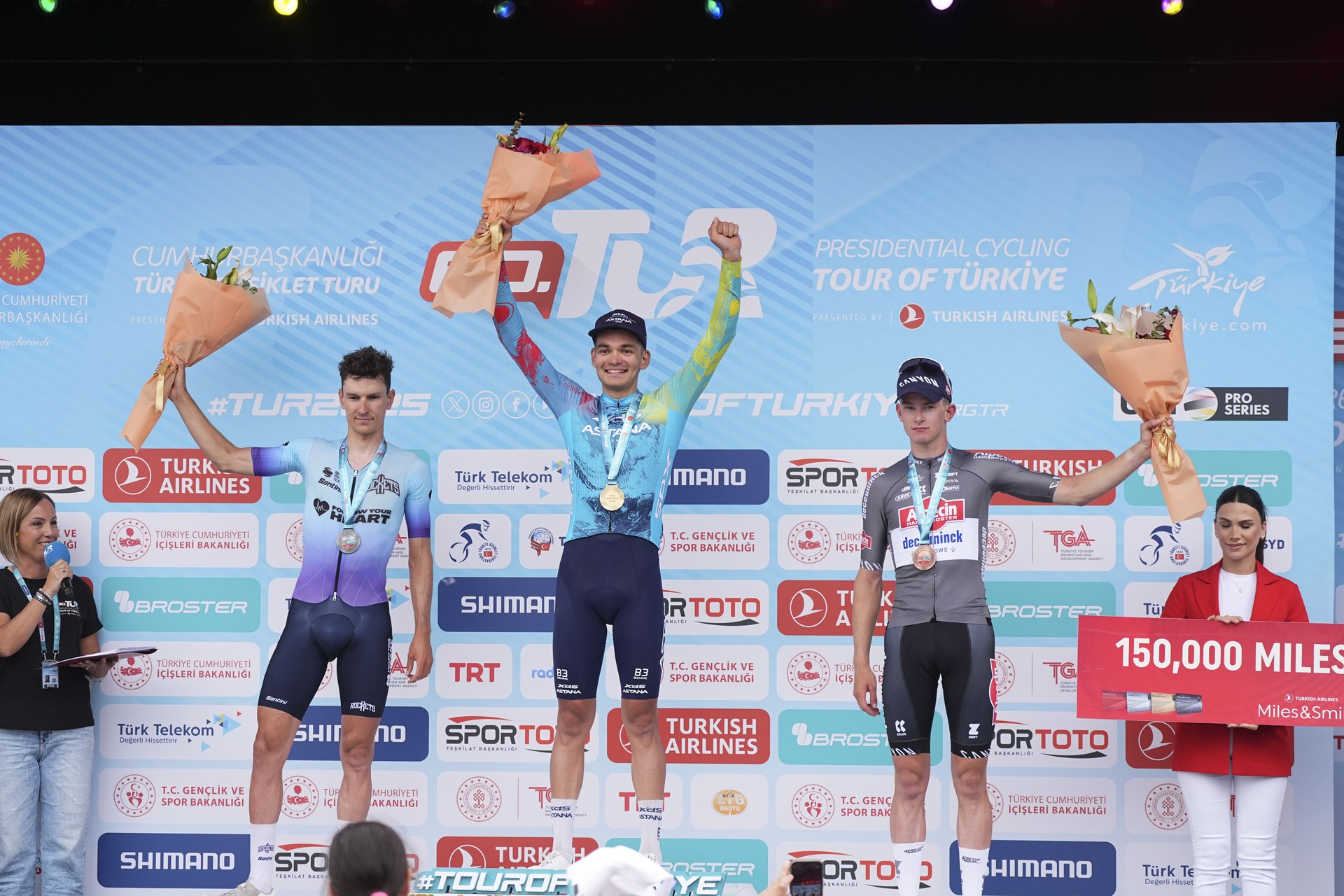 Lev Gonov (M) of the XDS Astana team celebrates winning the Fethiye-Marmaris 3rd stage, with Belgian cyclist Lander Loockx (L) of the Tietema Rockets team finishing second and Dutch rider Tibor Del Grosso (R) of the Alpecin-Deceuninck team taking third place, at the 60th Presidential Cycling Tour of Türkiye in Antalya on April 29, 2025. (AA Photo)
