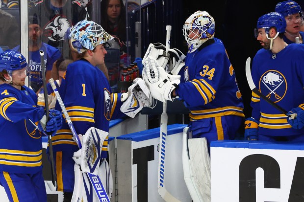 Buffalo Sabres goaltender Alex Lyon, right, comes in for goaltender Ukko-Pekka Luukkonen, left, during the third period in Game 2 of a first-round NHL Stanley Cup playoff series against the Boston Bruins Tuesday, April 21, 2026, in Buffalo, N.Y. (AP Photo/Jeffrey T. Barnes)