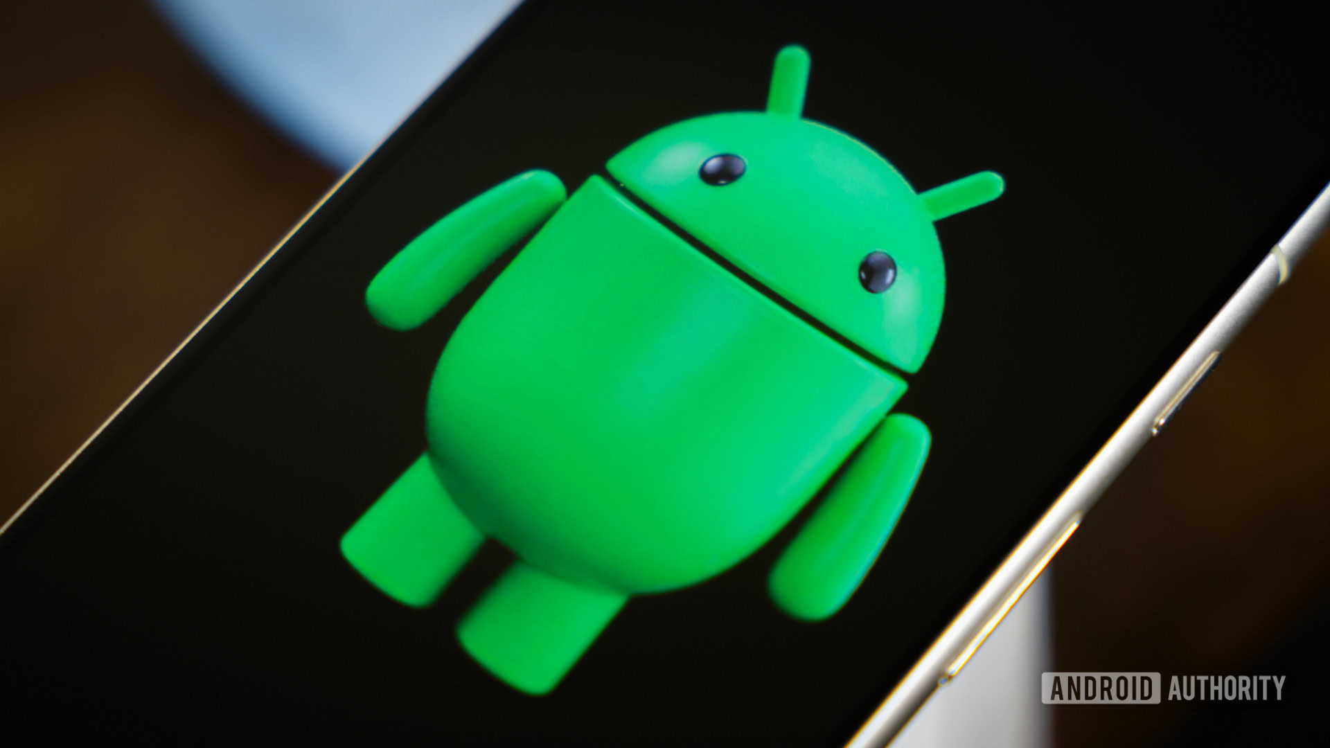 Android robot on smartphone next to other devices and accessories (3)