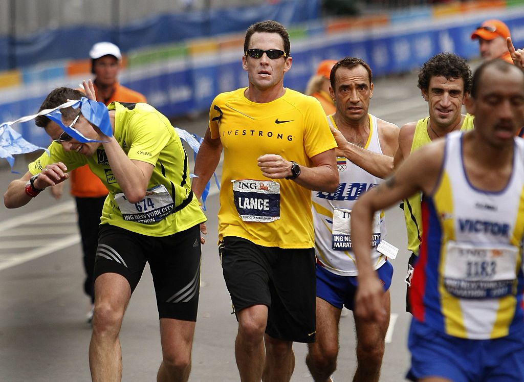Lance Armstrong (C), who retired from cycling after winning an unprecedented seven straight Tour de France, crosses the finish line of the New York City Marathon in New York 04 November 2007. AFP PHOTO/TIMOTHY A. CLARY (Photo by TIMOTHY A. CLARY / AFP) (Photo by TIMOTHY A. CLARY/AFP via Getty Images)