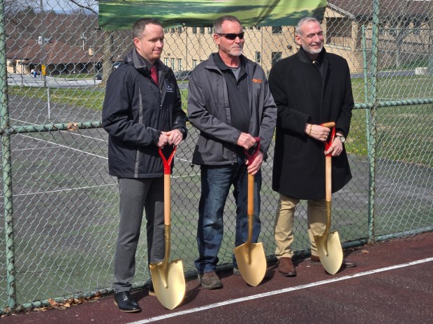 From left: Nick Hill, deputy chief executive officer and chief human resources officer at Bethany Children's Home; Wesley Powers, owner and president, Lancaster Asphalt Systems; and Dr. Joseph Birli, Bethany president and chief executive officer, take up golden shovels in celebration of a donor-funded project to renovate Bethany's basketball court. (Keith Dmochowski - Reading Eagle)
