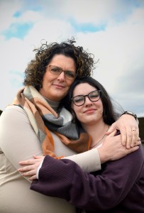 Mother and daughter hugging on each other.