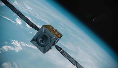 Artist's illustration of a cube-shaped satellite with two large solar wings in orbit above Earth