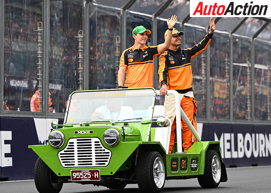 Oscar Piastri and Lando Norris riding on a Mini Moke during the drivers' parade at the Australian Grand Prix in Melbourne.