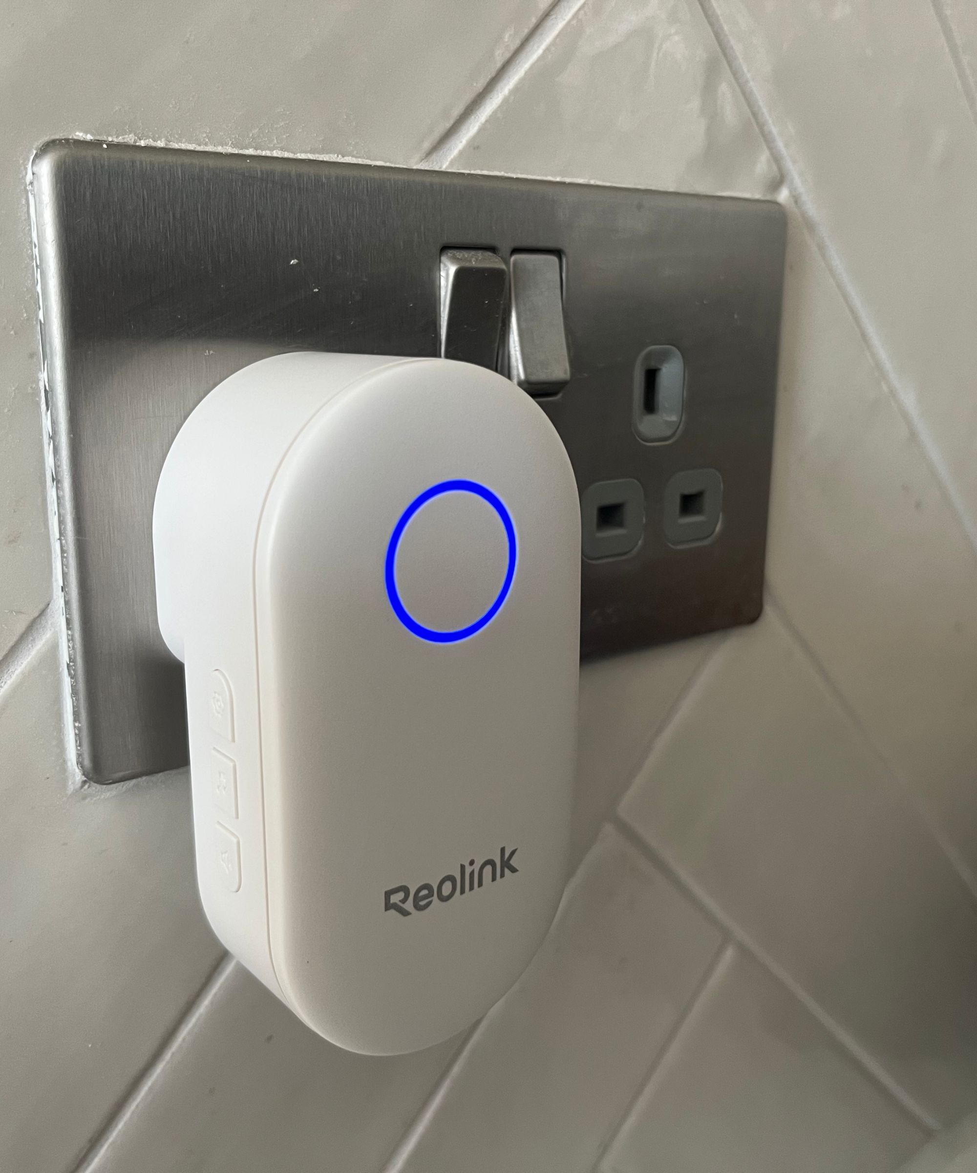 Reolink Chime plugged in to wall socket with blue light illuminated.