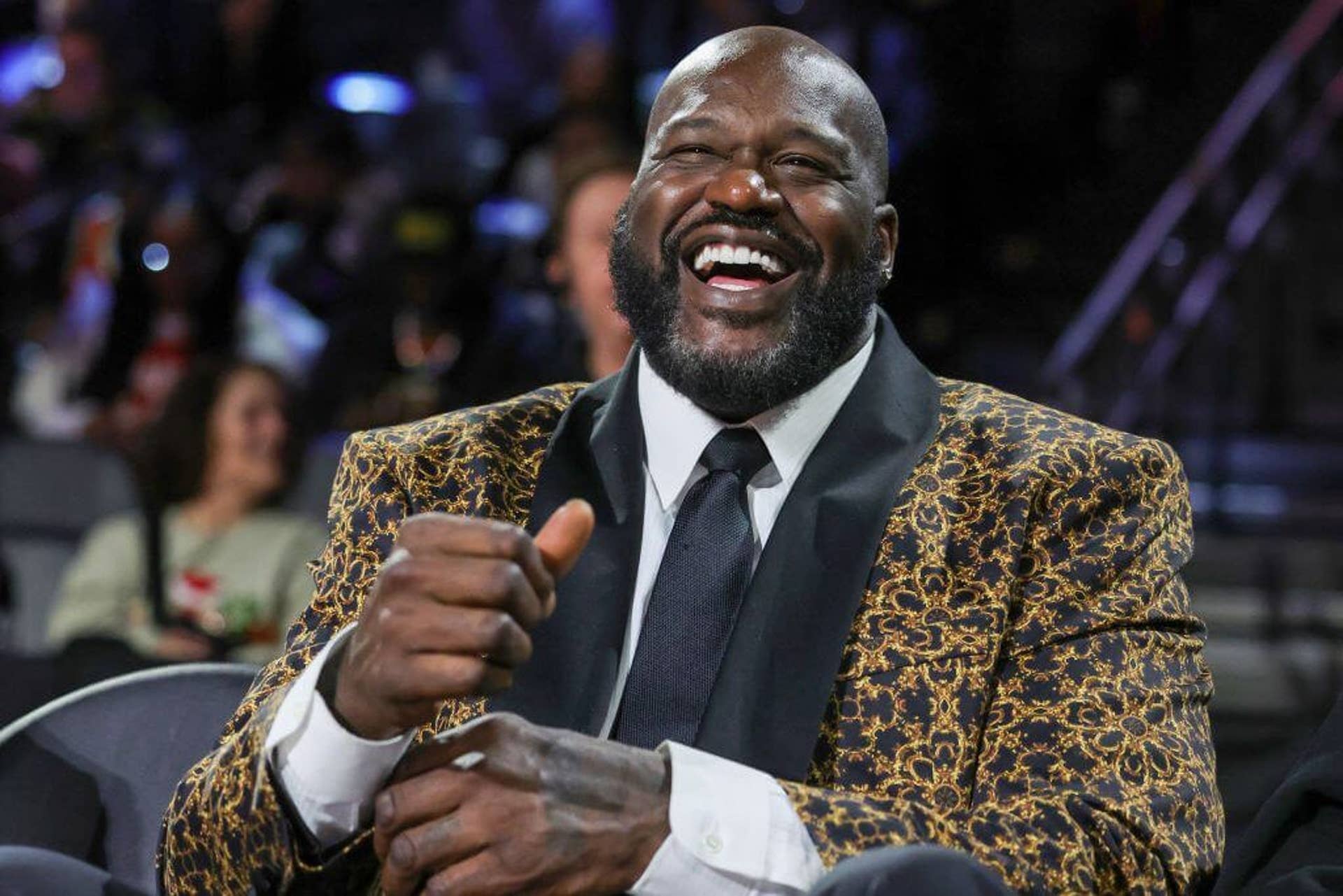 Shaquille O'Neal laughs on camera.