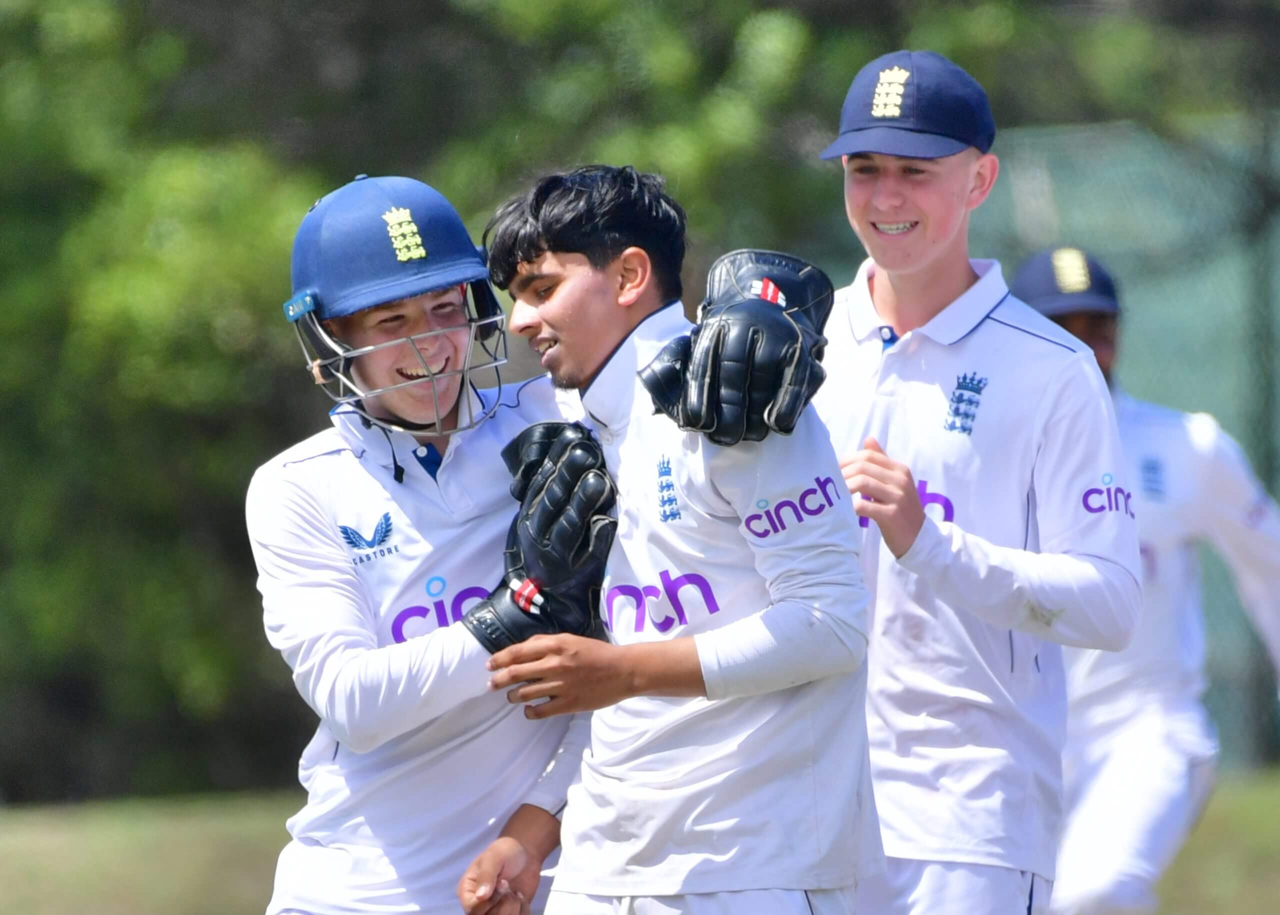 Farhan Ahmed is congratulated by his England Under-19 team-mates in Cape Town in February 2025