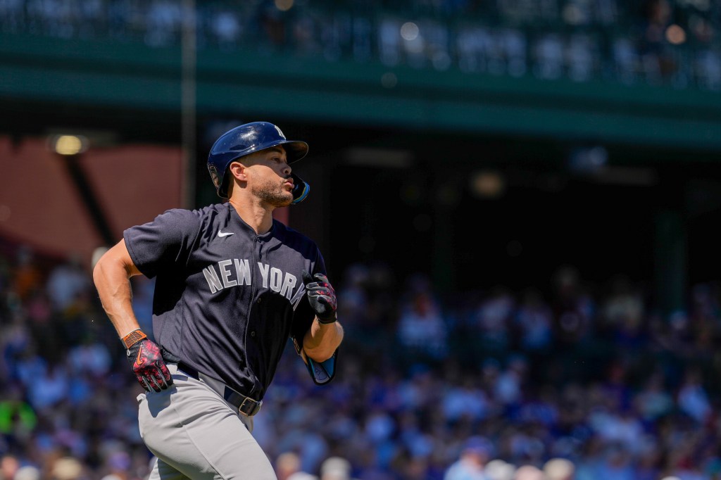 Giancarlo Stanton #27 of the New York Yankees runs to first base during the game between the New York Yankees and the Chicago Cubs at Sloan Park on Monday, March 23, 2026 in Mesa, Arizona.