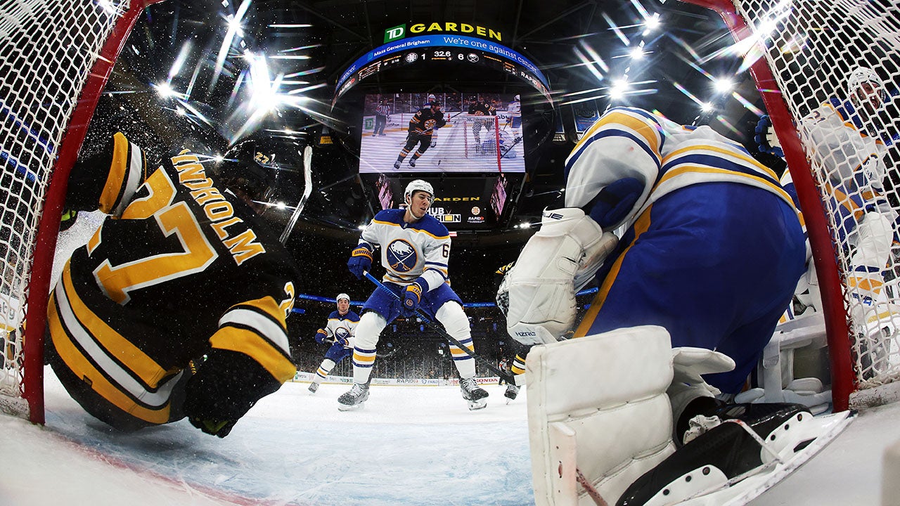 BOSTON, MASSACHUSETTS - APRIL 26: Logan Stanley #64 of the Buffalo Sabres defends the net as Hampus Lindholm #27 of the Boston Bruins crashes into it during Game Four of the First Round of the 2026 Stanley Cup Playoffs at TD Garden on April 26, 2026 in Boston, Massachusetts. The Sabres defeat the Bruins 6-1. (Photo by Maddie Meyer/Getty Images)