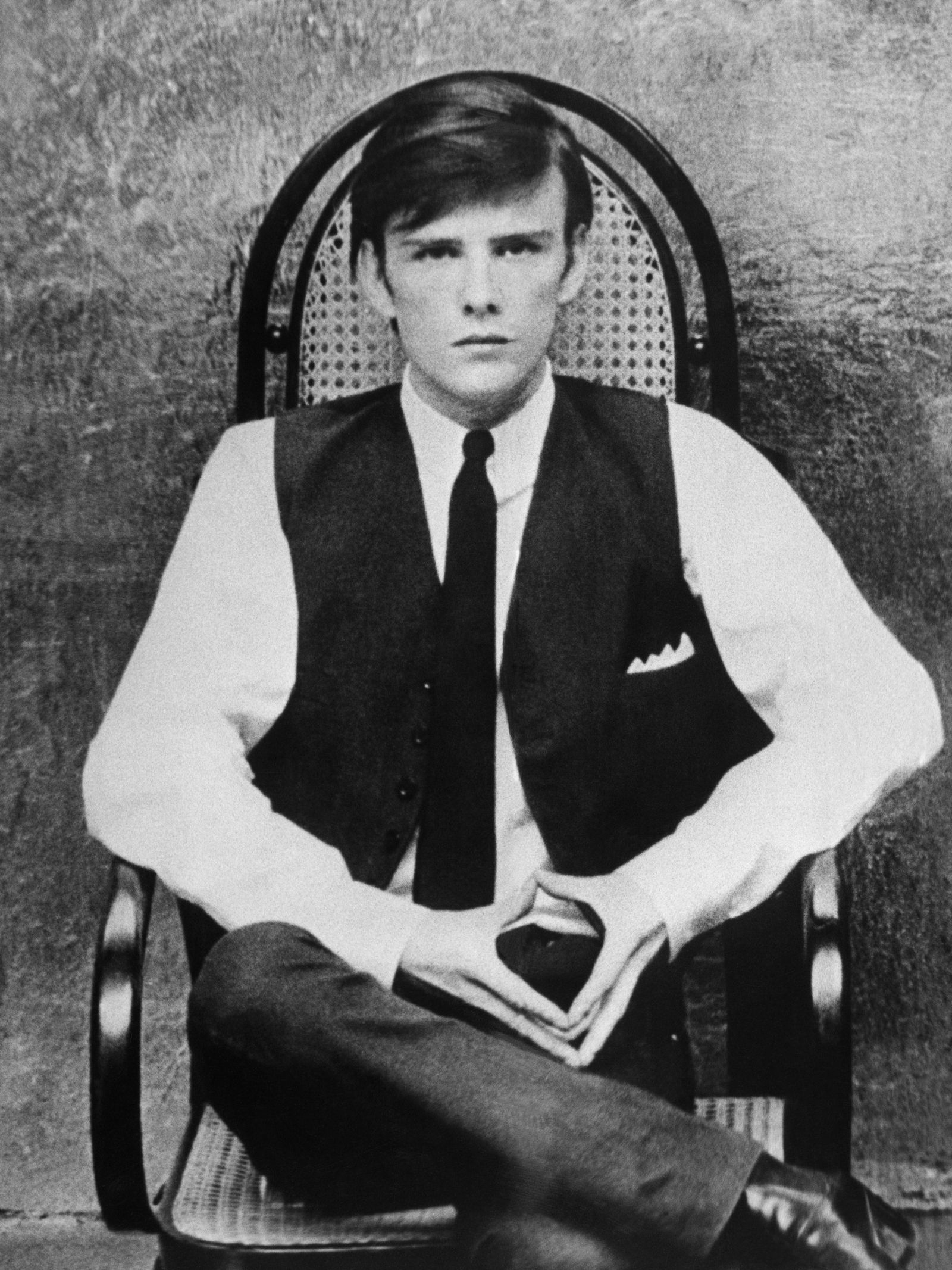 Image may contain Stuart Sutcliffe Person Sitting Face Head Photography Portrait Adult Formal Wear and Clothing