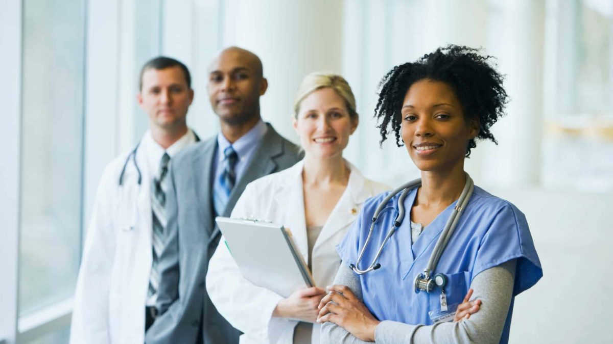 Smiling health care workers in a medical setting.