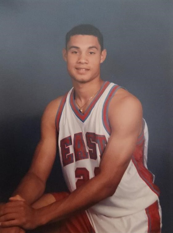 Trajan Langdon posing for a basketball photo in his jersey.