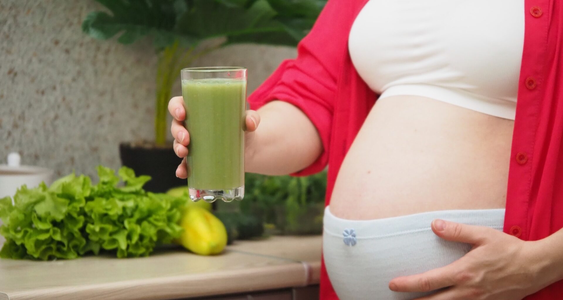 Pregnant Woman drinking green smoothie