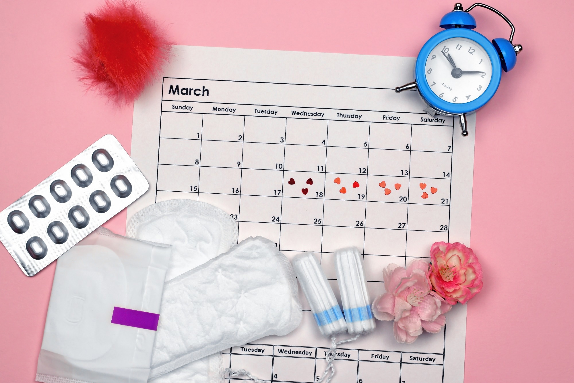 Menstrual pads and tampons by the period of the menstrual cycle on a pink background