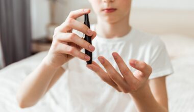 Teen boy takes a blood sample for diabetes with lancet pen. Problems of diabetes and insulin resistance in childhood