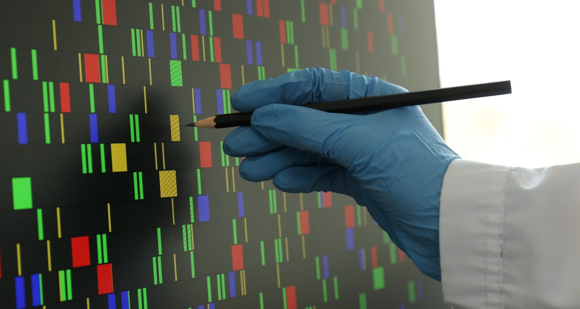Scientist analyzing DNA data in laboratory, closeup