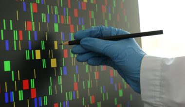 Scientist analyzing DNA data in laboratory, closeup