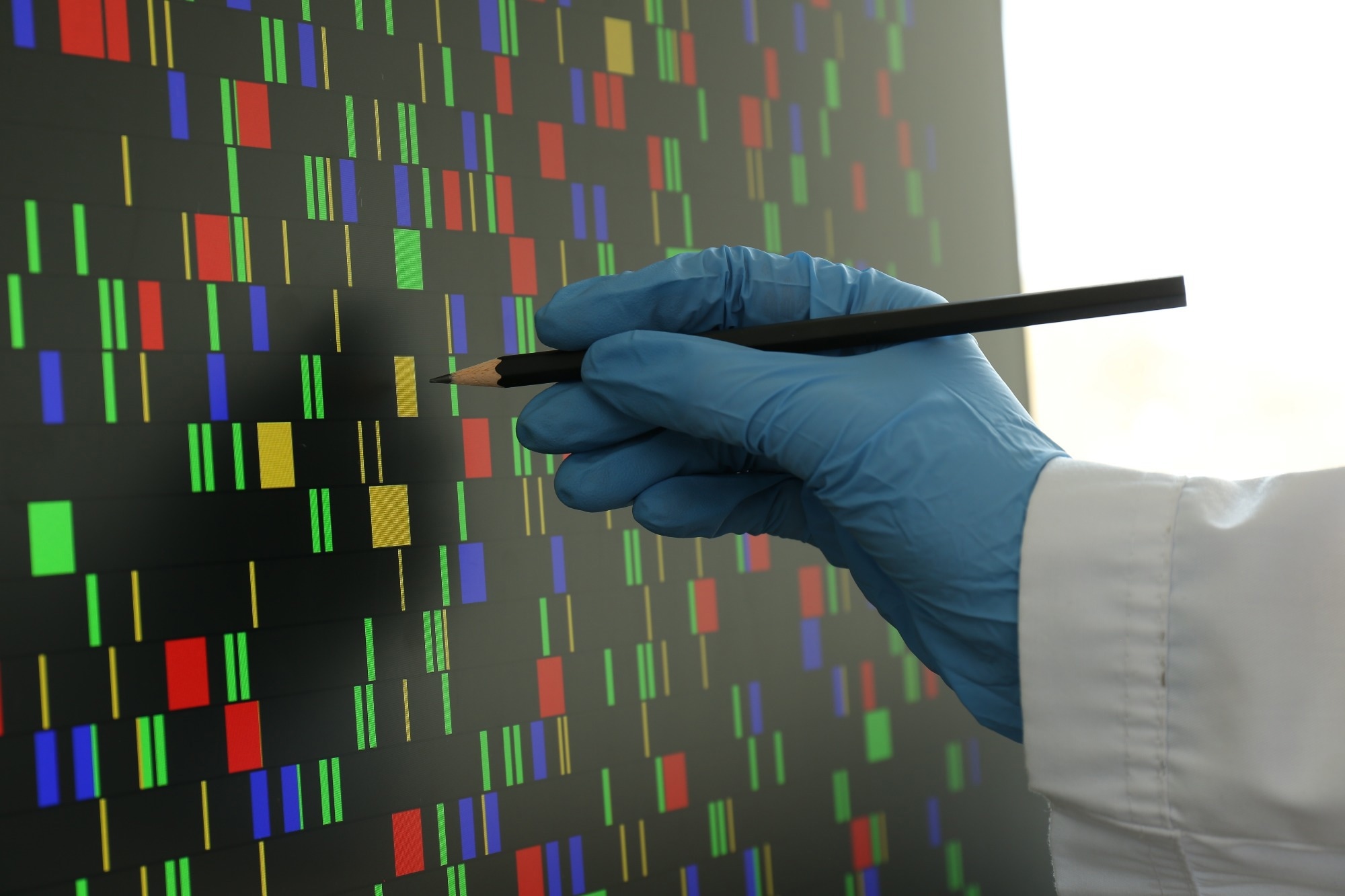 Scientist analyzing DNA data in laboratory, closeup