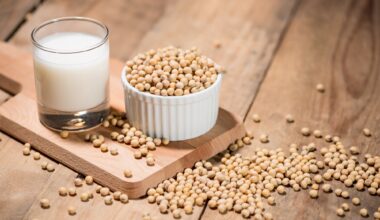 Soy milk or soya milk and soy beans on wooden table.